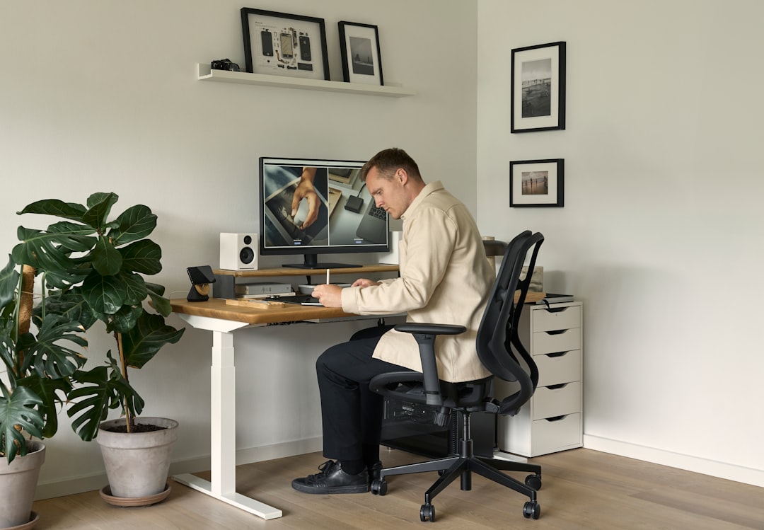 A man sitting at a desk in front of a computer