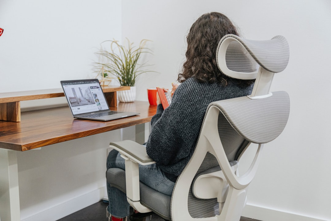 a woman sitting at a desk with a laptop