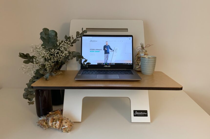 black laptop computer on white wooden desk